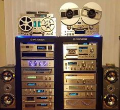 an array of audio equipment sitting on top of each other in front of a wall