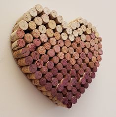 a heart shaped wine cork display on a wall