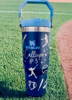 a blue tumbler sitting on top of a baseball field