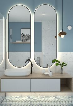 a bathroom with two large mirrors on the wall and a sink in front of it