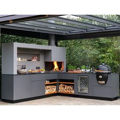 an outdoor kitchen with a grill and fire pit