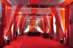 a red and white wedding setup with draping