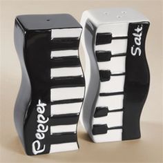 two black and white piano salt and pepper shakers with the words safe on them