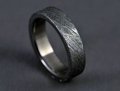 a wedding band that has been made to look like an intricate pattern on the inside of it