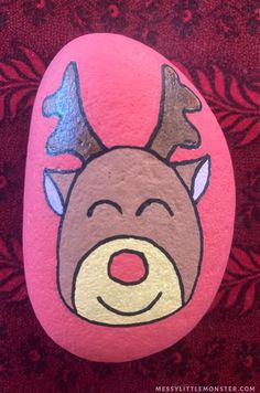 a painted rock with a reindeer's head on it