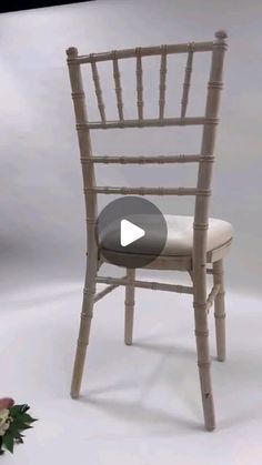 a chair made out of bamboo with a flower on the side and a video screen showing how to use it