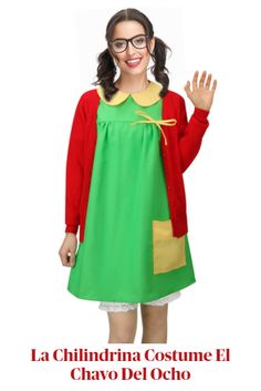 a woman in a green dress and red cardigan is waving at the camera while wearing glasses