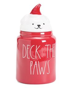 a red cookie jar with a white bear face on it and the words deck the paws