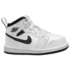 Retro-Inspired Style Outfit your child in the Jordan Toddler Boys’ AJ 1 Mid sneaker featuring a mid-top design inspired by the original AJ1 from 1985. It has many of the same features as that iconic first shoe, such as a leather-and-synthetic upper that’s durable and stylish. The classic appearance of the Jordan AJ 1 Mid coordinates well with kids’ casual clothes. With multiple colorways available, you’re sure to find one both you and your child will love. The classic Nike Swoosh appears on the Baby Jordan Shoes, Jordan Aj 1 Mid, Baby Jordans, Mid Top, Nike Swoosh, Casual Clothes, Boy Mom, Black Boys, Top Design