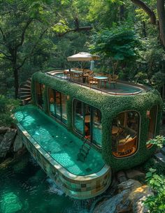 a house boat that is floating in the water surrounded by greenery and trees with an umbrella on top