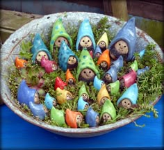 a bowl filled with lots of little gnomes