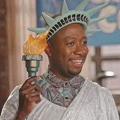 a man holding a brush with the statue of liberty on it's head