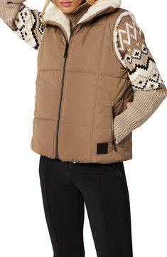 Meet the cold-weather in total comfort with this versatile vest featuring a quilted shell that's water repellent and a plush faux-shearling reverse for lasting warmth. 24 1/2" length (size Medium) Front zip closure Stand collar Front zip pockets Quilted shell is water repellent Lined, with 100g/m² Primaloft® recycled polyester PrimaLoft® lightweight insulation retains warmth in wet or dry conditions 100% polyester; 100% polyester faux shearling reverse Imported Faux Shearling Vest, Quilted Outerwear, Shearling Vest, Reversible Vest, Outerwear Vest, Quilted Vest, Denim Leggings, Swimsuit Cover, Comfortable Dress