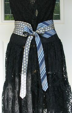 a black dress with blue and white striped ties on it's belted waist