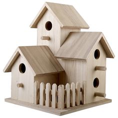 three wooden bird houses sitting on top of each other