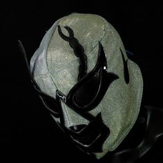 a black and white baseball cap with a bird on it's visor, against a black background