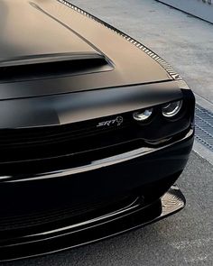 the front end of a black sports car