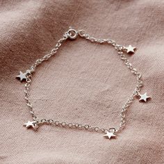 This Sterling Silver Star Station Bracelet bracelet is a beautiful addition to our celestial inspired jewellery. Its delicate charms have a flat, light-reflecting surface. Eye-catching layered with other delicate bracelets and bangles.  Made from: 925 Sterling silverDimensions: Each charm measures approximately 10mm in diameter. Length of bracelet is approx 19cm (7.5") We make our jewellery using the finest quality 925 Sterling Silver. Avengers Dr, Posh Totty, Slider Necklace, Anklet Chain, Celestial Design, Necklaces Women, Funky Jewelry, Jewelry Lookbook, Star Jewelry