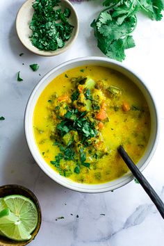 a white bowl filled with soup and garnished with cilantro