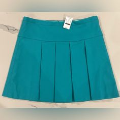 This Is A Classic Pleated Skirt In A Fun Bright Color, By J Crew Factory. Skirt Is A Bright Aqua Or Turquoise Blue. There Is A Drop Panel Before The Large Pleats, Which Creates A Flattering Almost A Line Shape. Skirt Is Fully Lined. Rear Middle Hidden Zipper Eight Metal Pull Size 12. Approximate Measurements Lying Flat: 17.25” Waist 17.5” Length Condition Is New With Tags! Casual Blue Pleated Mini Skirt, Blue Cotton Mini Pleated Skirt, High Waist Blue Pleated Mini Skirt, Pleated Blue Cotton Mini Skirt, Light Turquoise Pleated Skirt, Turquoise Skirt, Teal Skirt, Color Block Skirt, Gingham Linen