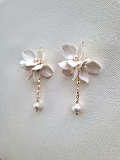 Delicate handmade 'Lucy' flowers arranged into beautiful cluster earrings with a dangling freshwater baroque pearl will make your bridal look extra special. Each flower is adorned with nugget pearl and attached to gold-filled or sterling hook earrings and gold filled or sterling silver chain. The total length of the earring is 4.5cm. Sent beautifully packaged in a Medze Bride gift box. As 'LUCY' earrings are made to order especially for you as well due to hygienic reasons I cannot accept refunds Handmade Bridal Earrings, Diy Bridal Earrings, White 14k Gold Filled Bridal Earrings As Gift, 14k Gold Filled White Bridal Earrings As Gift, Delicate White 14k Gold Filled Earrings, White 14k Gold Filled Earrings For Weddings, 14k Gold Filled White Bridal Earrings For Wedding, White 14k Gold Filled Bridal Earrings For Wedding, White 14k Gold-filled Pearl Earrings For Wedding