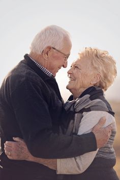 an older couple embracing each other in the desert