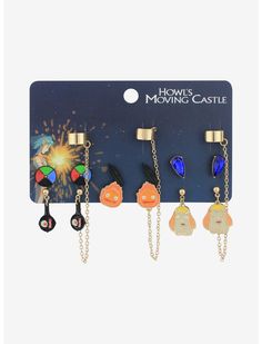 five pairs of earrings with charms hanging from the front and back of each earring