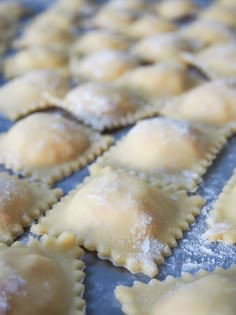 some ravioli sitting on top of a pan covered in powdered sugar