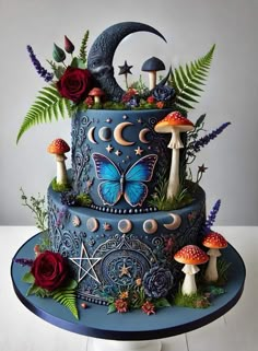 a three tiered cake decorated with mushrooms and flowers on a blue platter surrounded by greenery