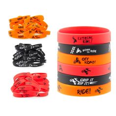 four different colored wristbands with black and orange designs