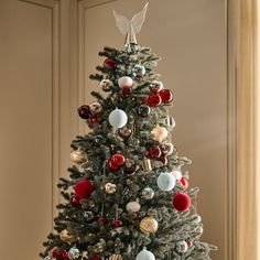 a decorated christmas tree with red, white and blue ornaments