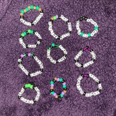 some beads that are on top of a purple blanket with the word boo spelled out