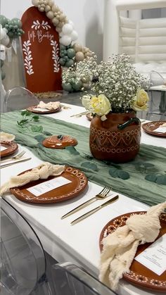 the table is set with place settings for two people to sit down and have their plates laid out on it