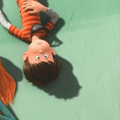 two children are laying on the ground with their heads down