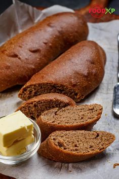 bread, butter and spoons on a table