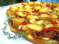 a pizza with pineapples and peppers on it is sitting on a white plate