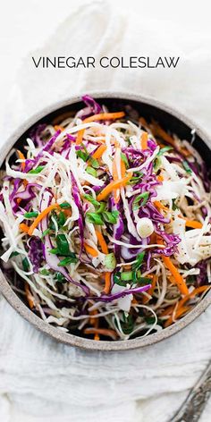 a bowl filled with coleslaw and carrots on top of a white cloth