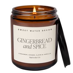 a candle that is sitting next to a white background with the words gingerbread and spice on it