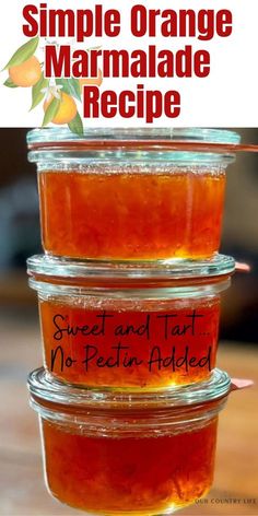 three jars filled with orange marmalade sitting on top of a wooden table