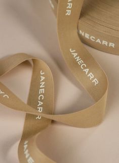 a close up of a ribbon on a white surface with the words lancarr printed on it