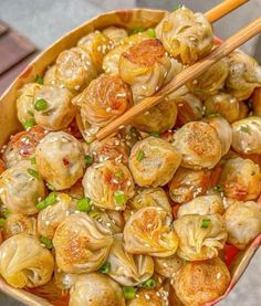 a bowl filled with dumplings and chopsticks