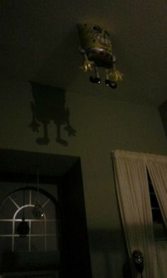 a room with a door, window and light fixture on the ceiling in it's shadow