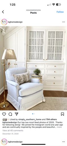 a white chair sitting in front of a window next to a lamp