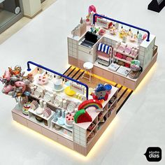 two models of a doll house with furniture and accessories