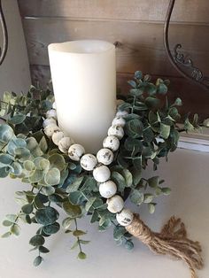 a white candle sitting on top of a table