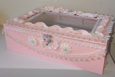 a pink box with pearls and bows on it