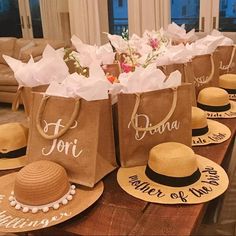 several bags with hats on them are sitting on a table in front of a couch