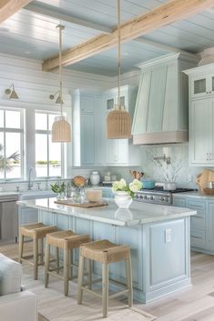 a kitchen filled with lots of counter top space and stools next to an island