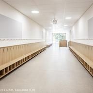 a long hallway with benches lined up against the wall