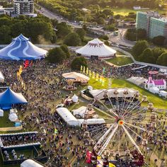 an aerial view of a fairground with many tents and people in the foreground